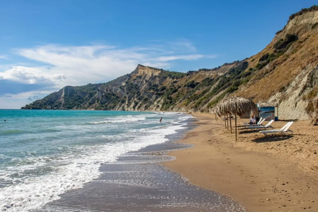 Wild and empty Arkoudilas Beach in southern Corfu with cliffs and calm sea