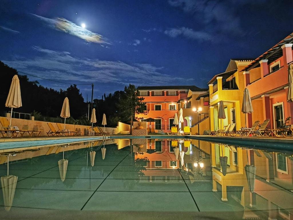 Outdoor pool at Sellas Hotel Sidari with sunbeds