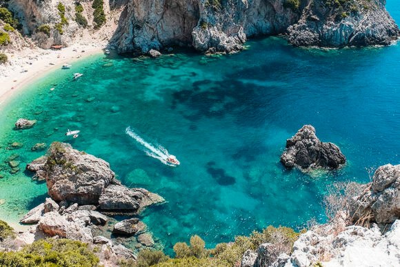 Small rocky Stelari Beach in Corfu with clear water and snorkeling spot