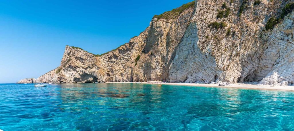 Paradise Beach Corfu with turquoise water and white cliffs viewed from boat