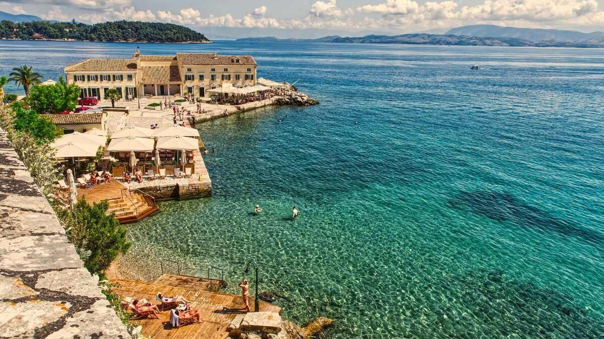 Scenic coastal village in Corfu with colorful buildings overlooking the sea