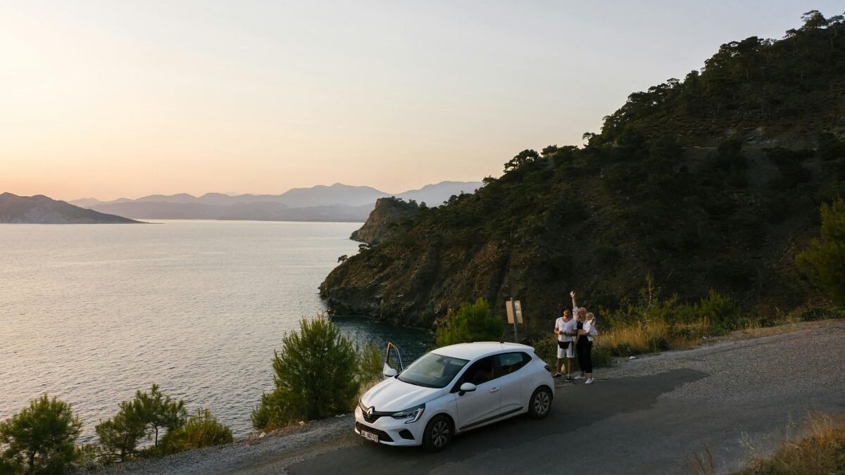 Rental car parked at a scenic viewpoint overlooking the coastline of Corfu