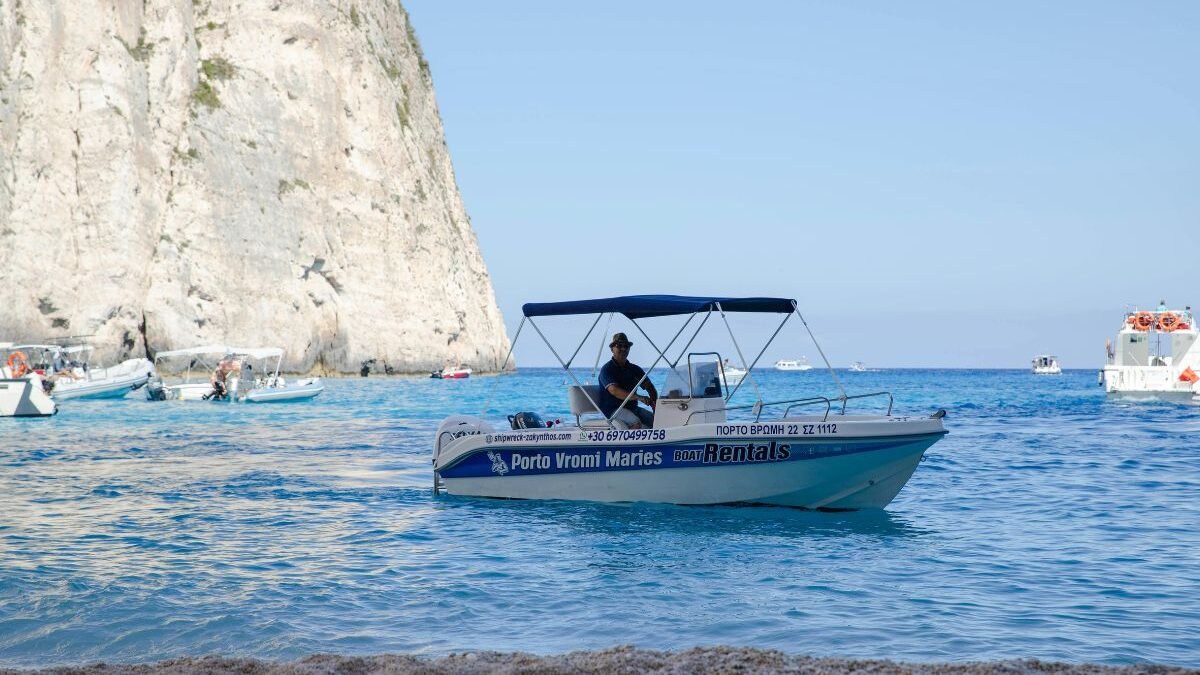 Tourists enjoying a boat trip along the coastline of Corfu