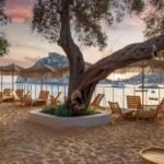 Beautiful panoramic view of Paleokastritsa in Corfu with turquoise water, dramatic cliffs, and luxury seaside hotels