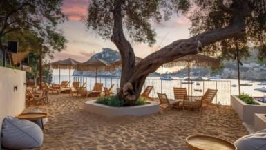 Beautiful panoramic view of Paleokastritsa in Corfu with turquoise water, dramatic cliffs, and luxury seaside hotels