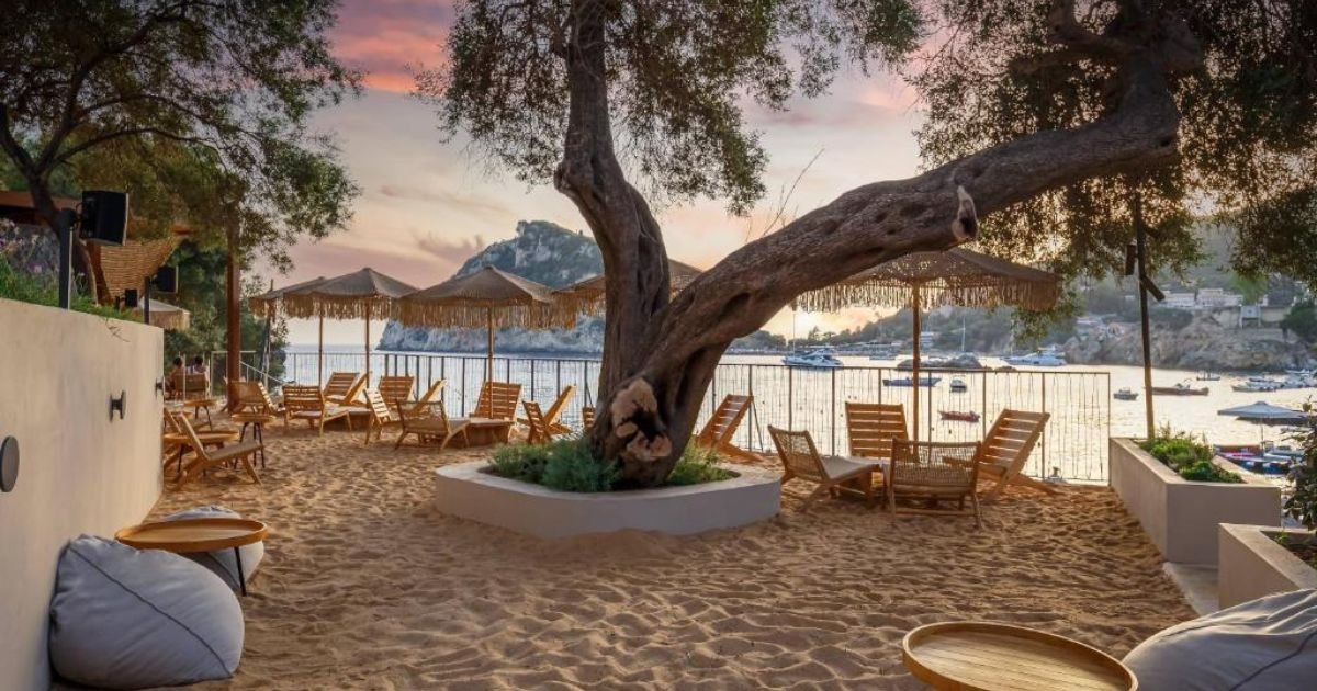 Beautiful panoramic view of Paleokastritsa in Corfu with turquoise water, dramatic cliffs, and luxury seaside hotels