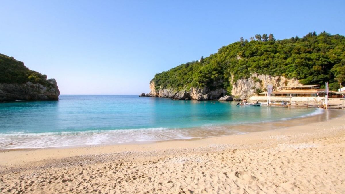 Small hidden coves and beaches in Paleokastritsa surrounded by rocky cliffs and clear shallow water.