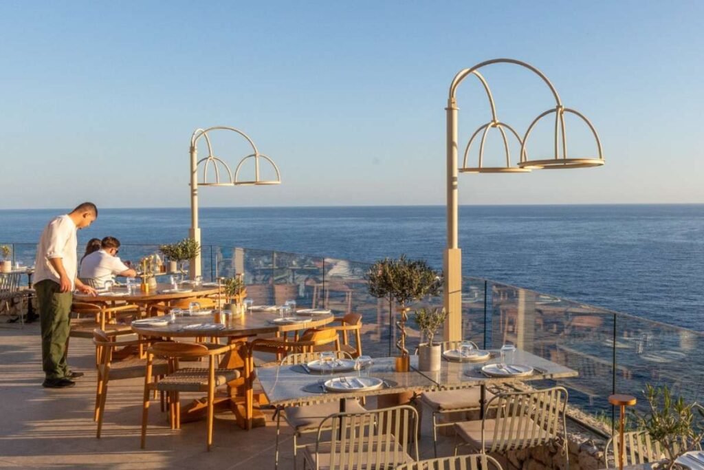 Sunset dining at Monastre Restaurant overlooking Ionian Sea coastline.