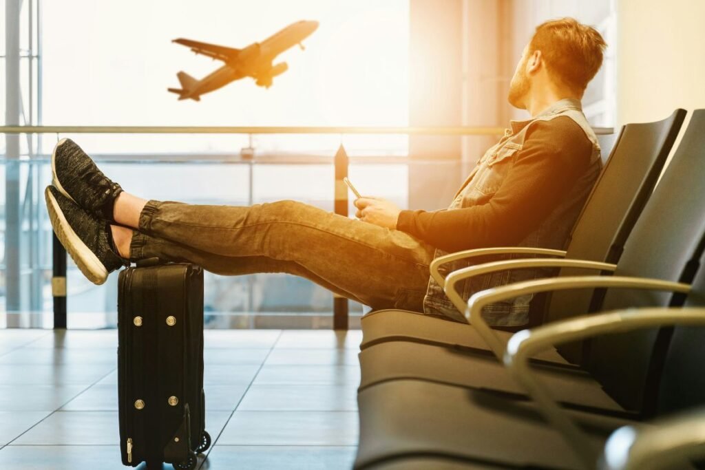 Passengers waiting at the airport due to a delayed flight with luggage