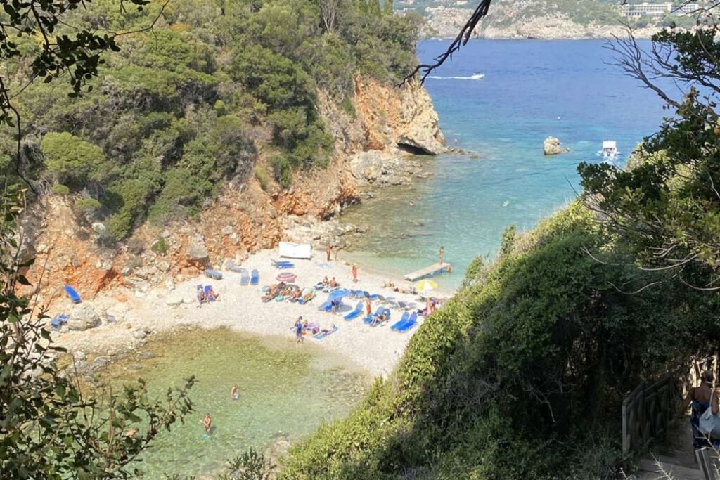 Quiet Limni Beach near Paleokastritsa with calm blue water and rocky coast