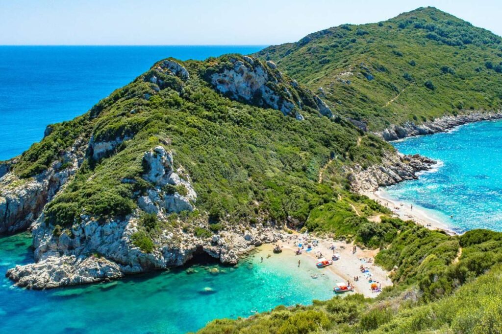 Aerial view of Porto Timoni double beach with turquoise water and green hills in Corfu