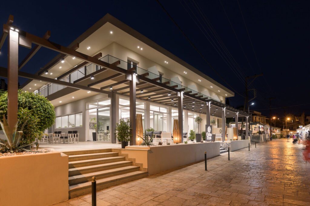 Exterior view of Melina Oasis Boutique Hotel overlooking Kassiopi Harbor in Corfu