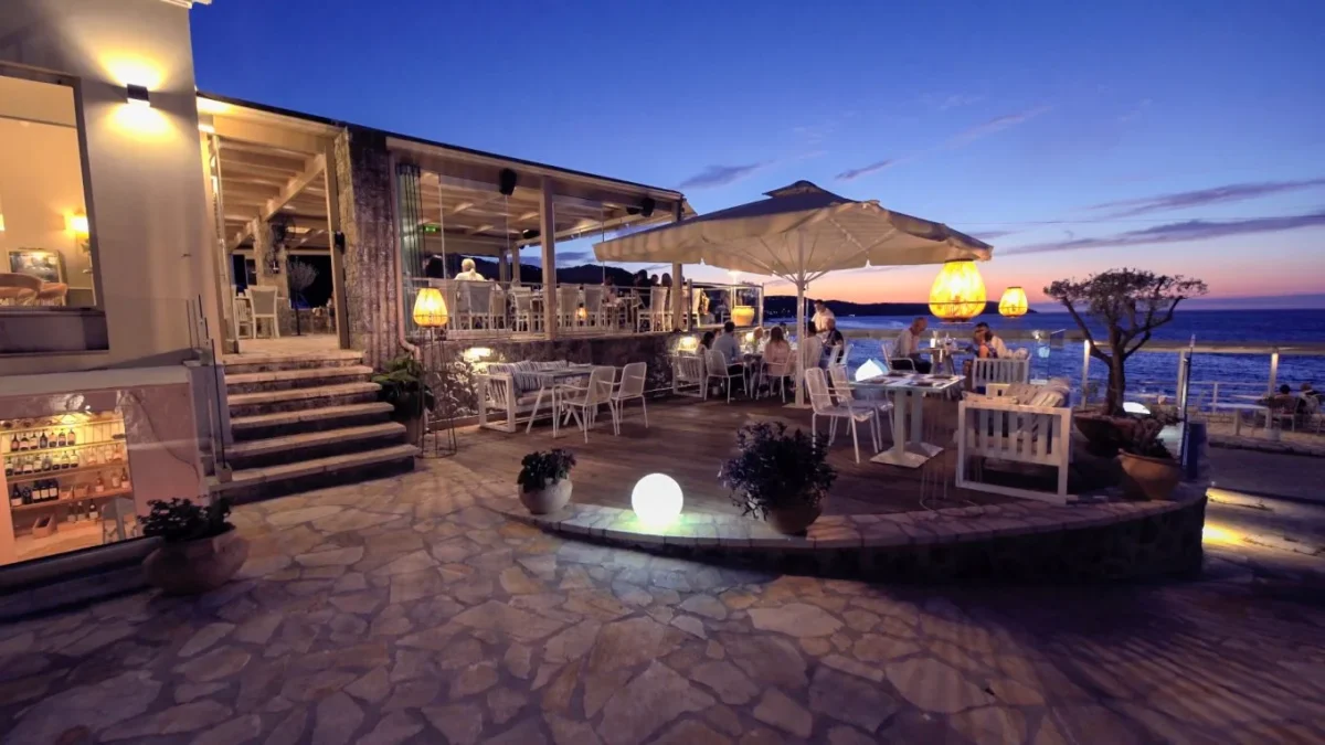 Outdoor terrace at Trilogia Restaurant in Kassiopi with elegant seating and panoramic sea views.