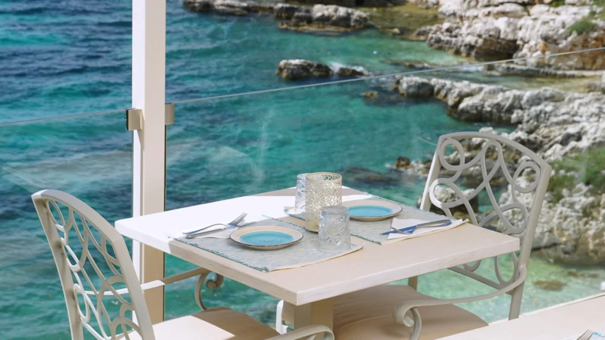 Romantic table for two at Trilogia Restaurant with a breathtaking sea view in Kassiopi, Corfu.