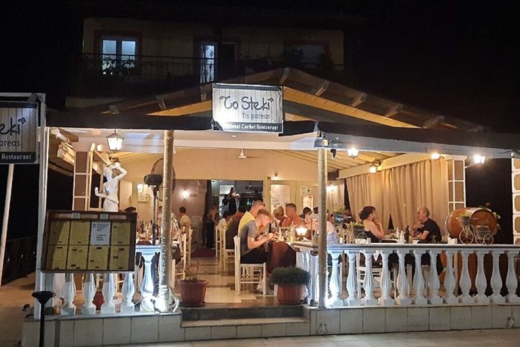 To Steki tis Pareas restaurant at night with guests dining outdoors