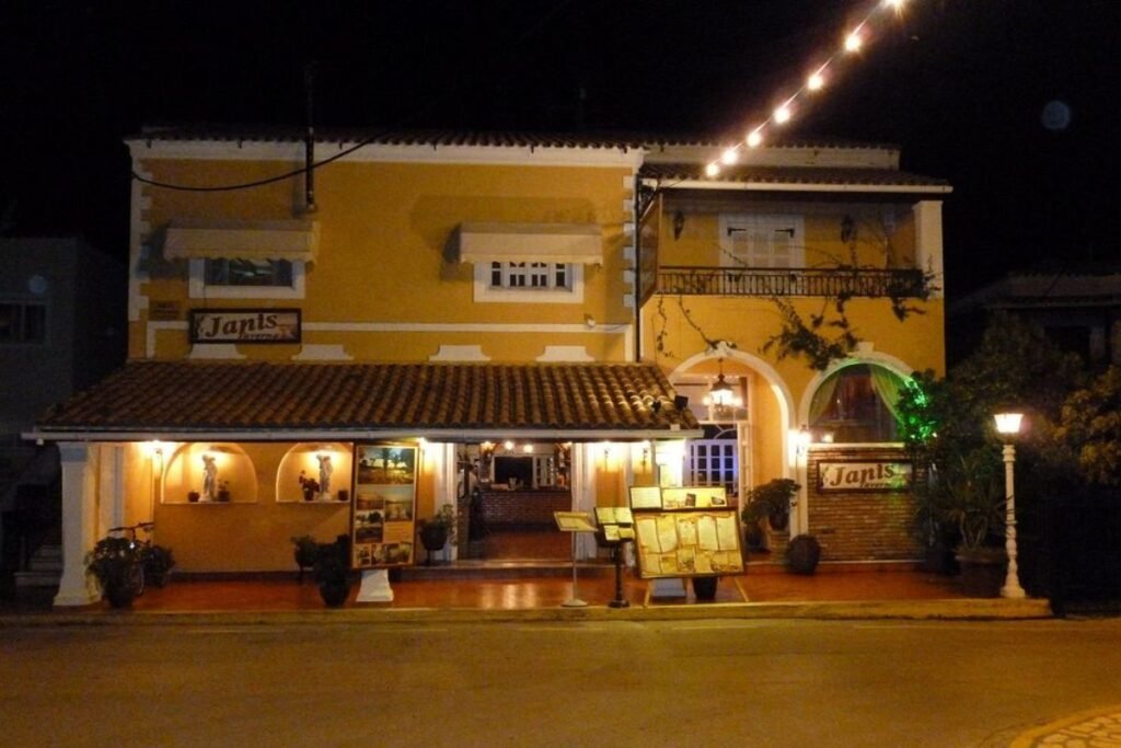 Exterior view of Janis Taverna restaurant in Kassiopi, Corfu, welcoming visitors with its traditional Greek atmosphere.