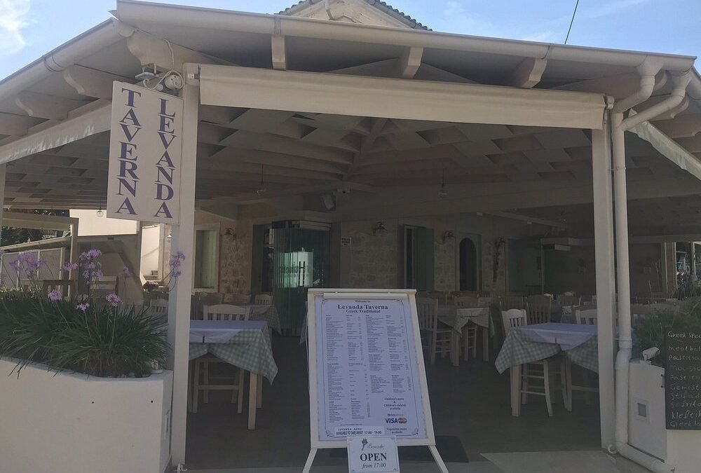 Exterior entrance and restaurant sign of Taverna Levanda in Kassiopi, Corfu.