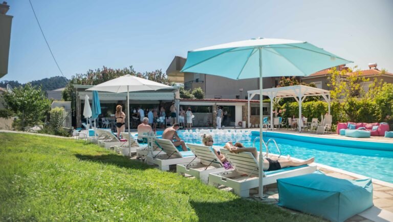Guests relaxing beside the pool at Macedon Hotel