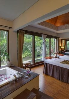Couple relaxing in private pool villa in tropical jungle Ubud