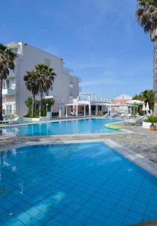 Sidari Beach Hotel swimming pool area with sun loungers and relaxing summer atmosphere in Corfu