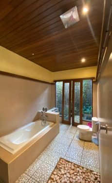 Small boutique hotel buildings in lush garden setting in Tegallalang