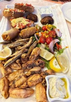 Large platter of traditional Greek dishes and Mediterranean specialties served at Janis Taverna in Kassiopi.