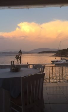 Sunset view over the sea from the outdoor terrace of Kima Restaurant in Kassiopi, Corfu.