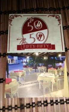 The 50/50 Greek Taverna sign in Sidari Corfu